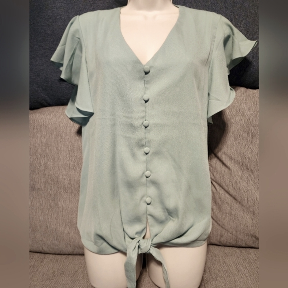 Light green, bell sleeve blouse, color is closest to the picture of it hanging.
